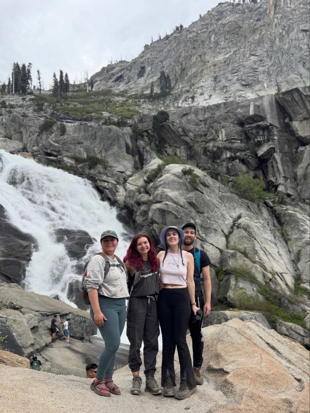 Ivey and friends hiking by a waterfall